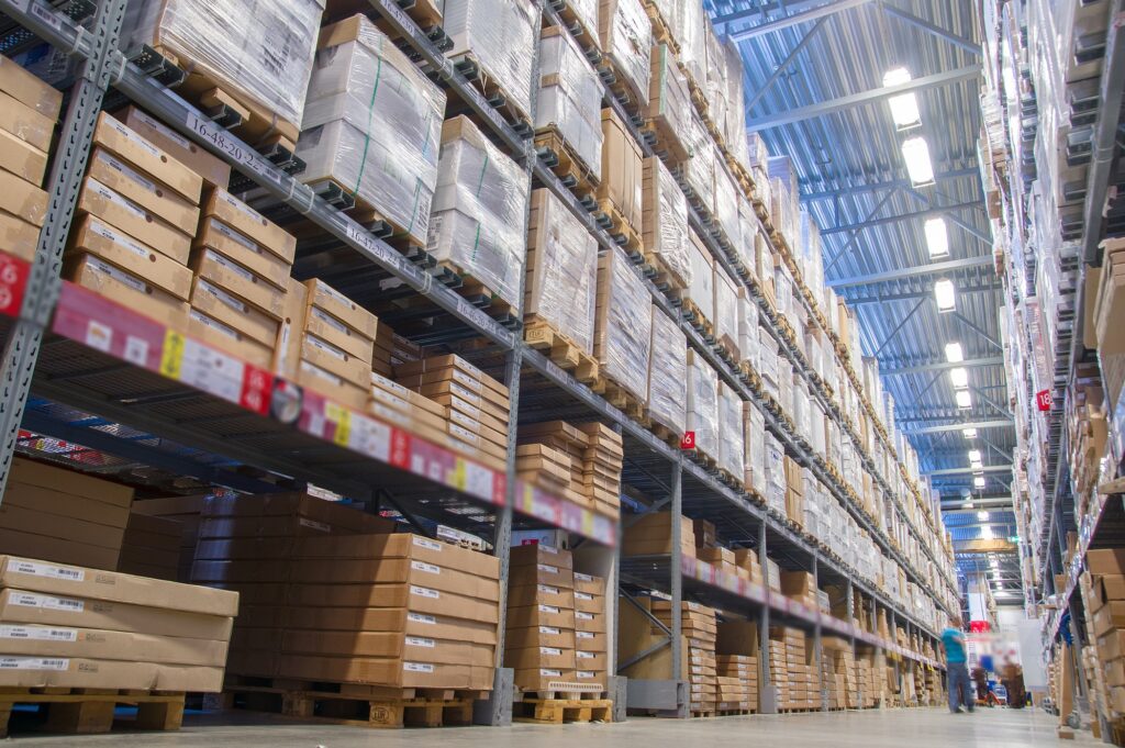 Rows of shelves with boxes in modern warehouse